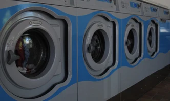 Washing machines operating in a laundry room with tiled flooring at Bon Repos