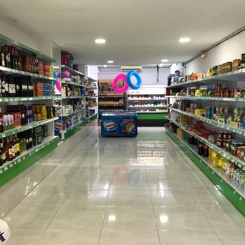 Grocery store aisle with stocked shelves and colorful floats hanging, in a brightly lit, clean environment at Armanello